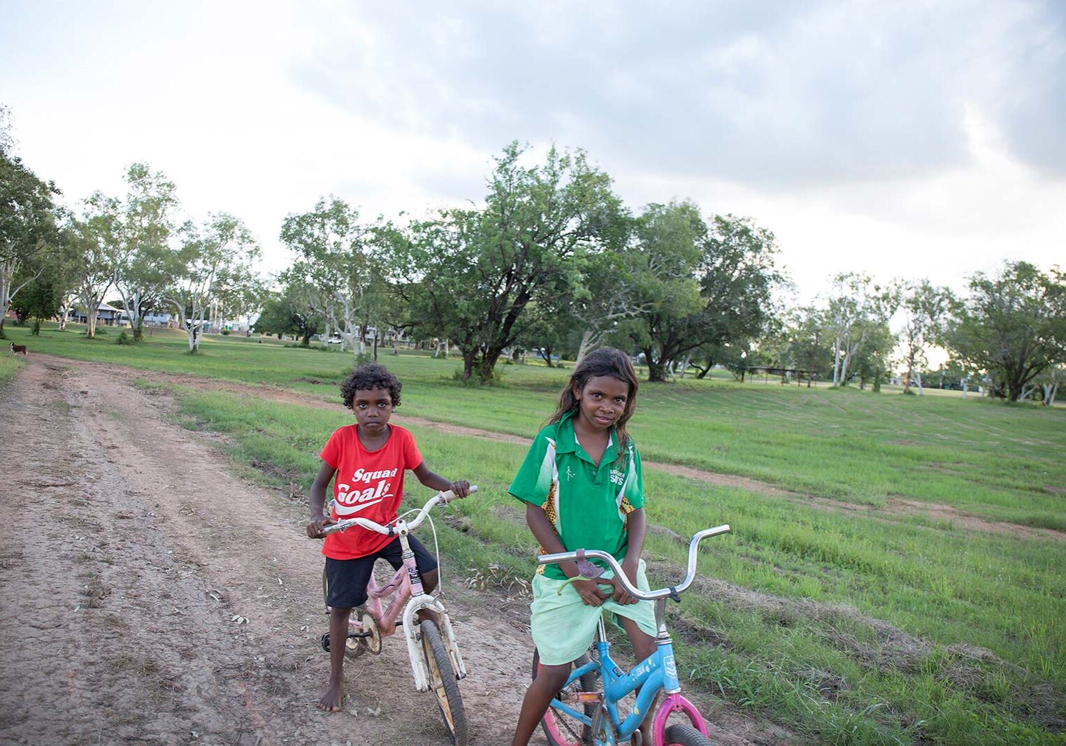 Aboriginal children playing on bikes on the Nauiyu Track near Merrepen Arts