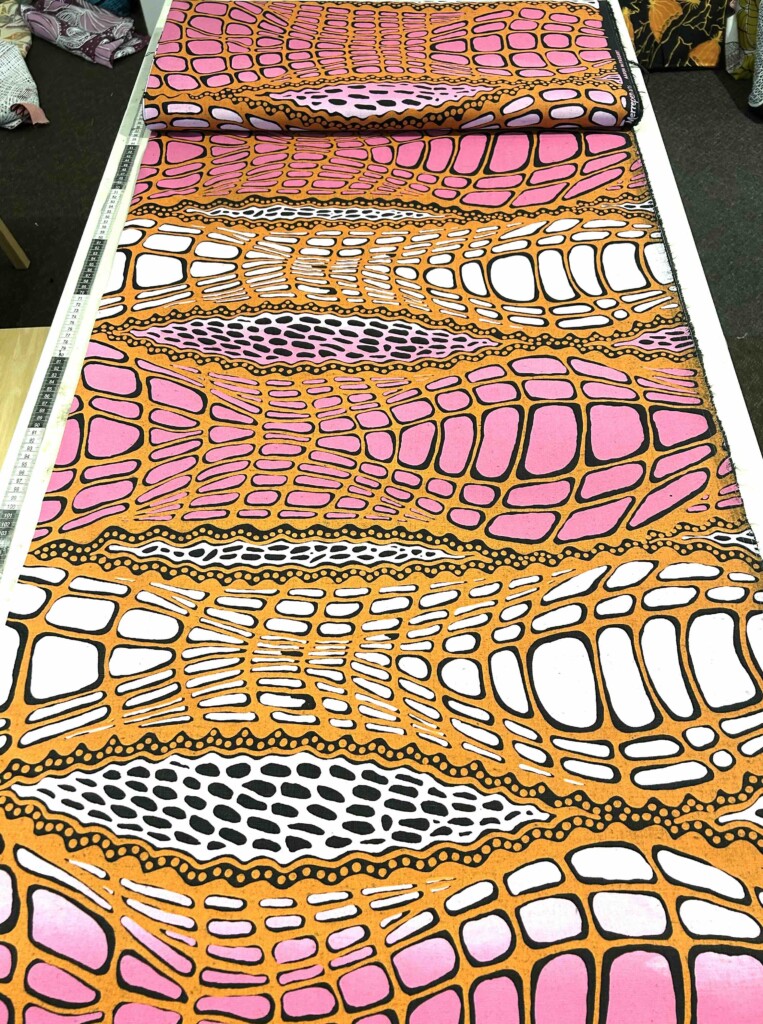 Aaron McTaggart - Crocodile Skin pink/orange on black linen (per 1m) - Image 4